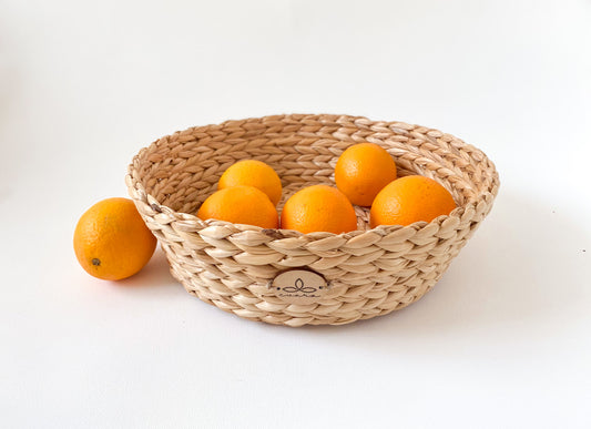 Evara’s artisanal storage basket handcrafted from 100% natural banana fiber, designed with a sturdy woven structure, minimalist aesthetic, and smooth natural finish. Ideal for organizing living spaces, storing linens, toys, or accessories. Lightweight yet durable, with reinforced edges and optional handles for easy mobility. A biodegradable, eco-friendly home décor piece that blends functionality with timeless elegance.
