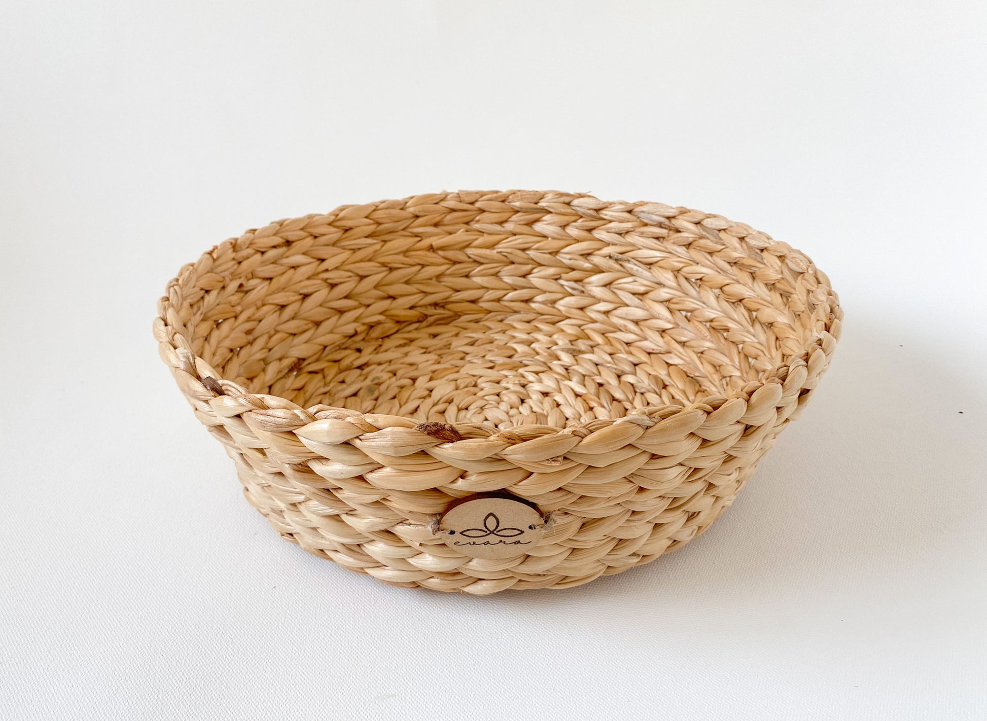 Evara’s artisanal storage basket handcrafted from 100% natural banana fiber, designed with a sturdy woven structure, minimalist aesthetic, and smooth natural finish. Ideal for organizing living spaces, storing linens, toys, or accessories. Lightweight yet durable, with reinforced edges and optional handles for easy mobility. A biodegradable, eco-friendly home décor piece that blends functionality with timeless elegance.