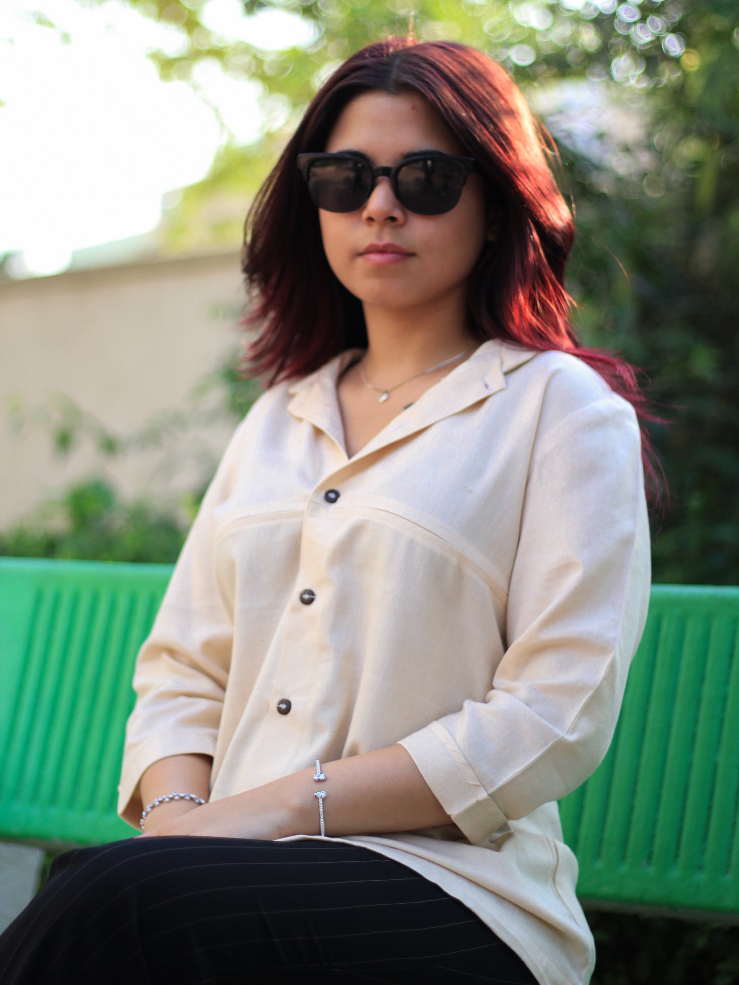 Model wearing Evara’s Buttercream Bliss Button-Down Shirt, crafted from a premium blend of banana fiber and cotton. This elegant three-quarter sleeve shirt in a golden hue features a mandarin collar, a structured yet relaxed fit, and a stylish button-down front. Designed for effortless versatility, it pairs perfectly with both formal and casual looks. Designed for consumers who appreciate natural fabrics and timeless fashion. Shop clothing at Evara.