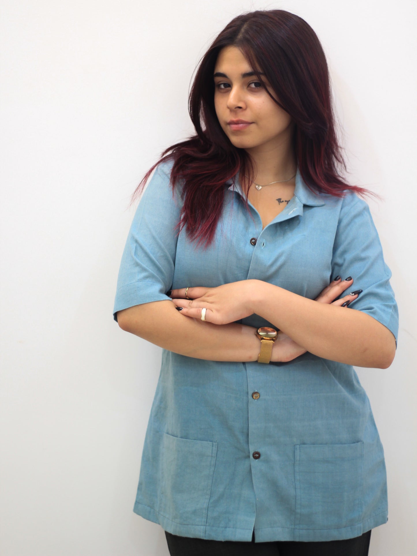 Model wearing Evara’s Aqua Petal Half-Sleeve Button-Down Shirt, made from a sustainable blend of banana fiber and cotton. This lightweight, breathable shirt features a structured silhouette, soft texture, and natural sheen, offering all-day comfort with moisture-wicking properties. A versatile wardrobe staple, ideal for casual and smart-casual looks. Shop eco-friendly fashion at Evara.