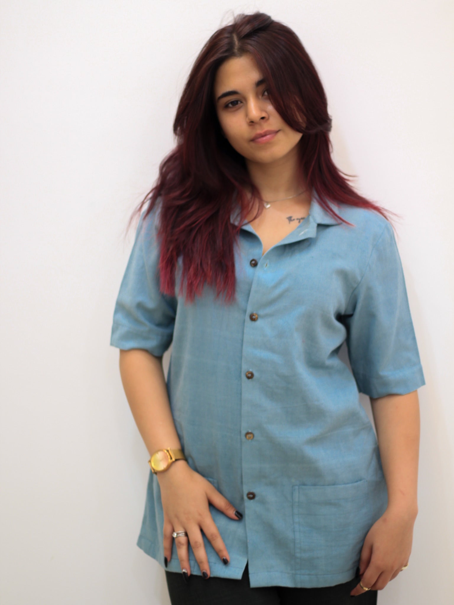Model wearing Evara’s Aqua Petal Half-Sleeve Button-Down Shirt, made from a sustainable blend of banana fiber and cotton. This lightweight, breathable shirt features a structured silhouette, soft texture, and natural sheen, offering all-day comfort with moisture-wicking properties. A versatile wardrobe staple, ideal for casual and smart-casual looks. Shop eco-friendly fashion at Evara.