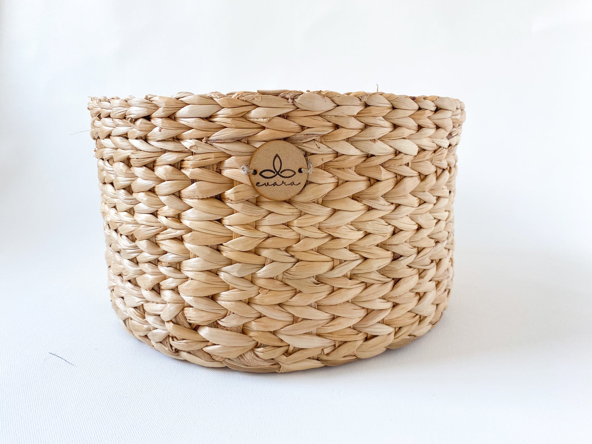Evara’s artisanal storage basket handcrafted from 100% natural banana fiber, designed with a sturdy woven structure, minimalist aesthetic, and smooth natural finish. Ideal for organizing living spaces, storing linens, toys, or accessories. Lightweight yet durable, with reinforced edges and optional handles for easy mobility. A biodegradable, eco-friendly home décor piece that blends functionality with timeless elegance.